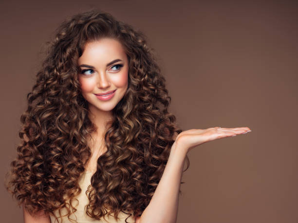 Beautiful woman with voluminous curly hairstyle